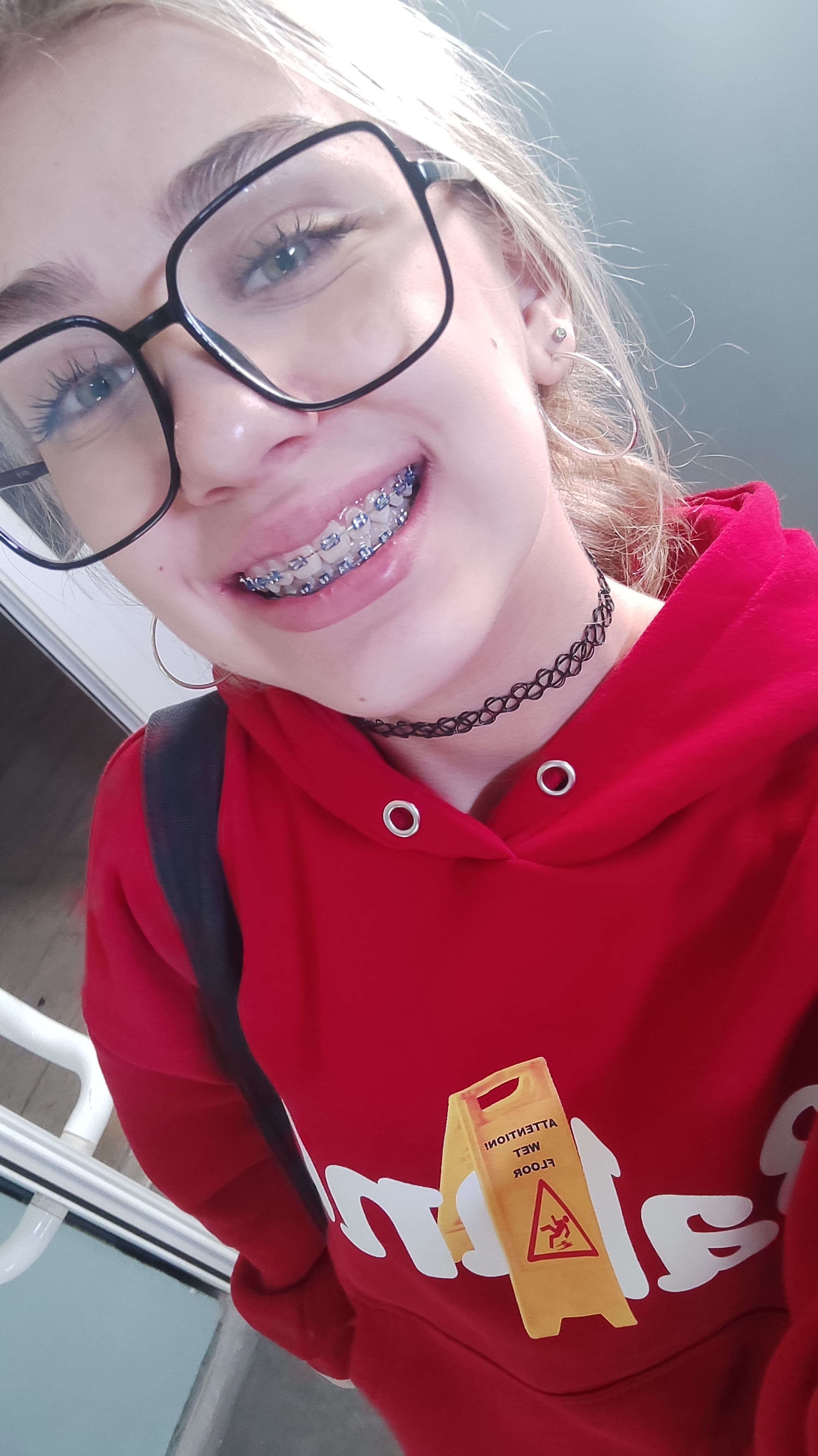 Candid smiling portrait with glasses and braces
